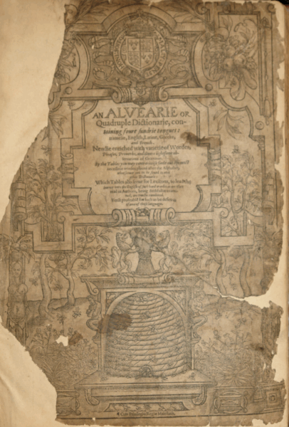A weathered, ornately illustrated title page of an early printed book titled An Alvearie or Quadruple Dictionarie. The book claims to contain “four sundrie tongues: namelie, English, Latine, Greeke, and French.” Decorative floral and architectural elements frame the text, with a prominent beehive illustration at the bottom center, symbolizing industrious learning. The top features a royal crest. The page shows signs of age, including tears, discoloration, and missing corners.